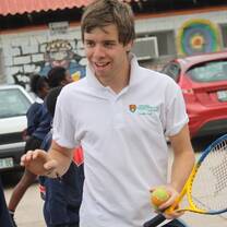 A volunteer coaching tennis
