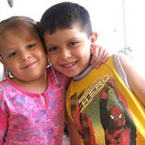 Smiling Argentinean children in pink and yellow