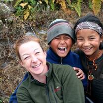 Volunteer taking a picture with local girls