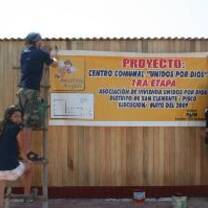 Volunteers hanging a sign in Peru
