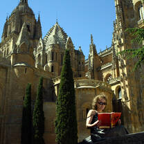 girl reading a book outside spanish cathedral 