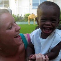 Volunteering holding a child in Haiti