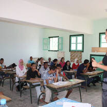 A volunteer teaching in front of a class
