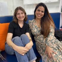 Two trainees smile at the camera