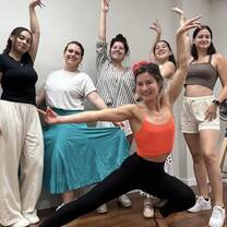 A group of girls poses as dancers