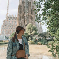 A girl looks at the Sagrada Familia cathedral