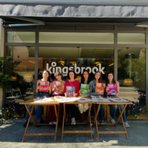 Students at Kingsbrook holding Aula Plus books