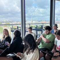 Students taking a class with a scenic European view during their study abroad program.
