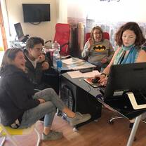 Teacher with some students looking at pc together