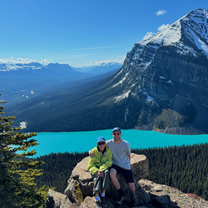 Two people in front of blues lakes + mountain views