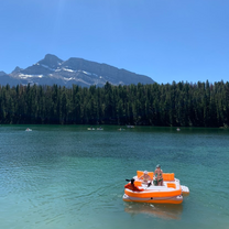 People out on a floatie on a blue lake on a summer day