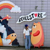 A girl standing in front of a graffiti wall in Revelstoke