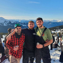 Three males at the top of a mountain