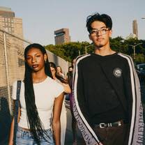 Two students walking next to the Brooklyn Bridge