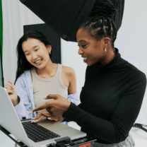 Two students collaborating in a studio on a photoshoot