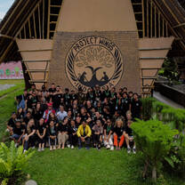 A drone shot of volunteers and the workers of the recycling village