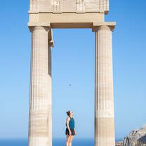 Students visiting the Acropolis of Lindos in Rhodes, exploring ancient Greek ruins overlooking the Aegean Sea