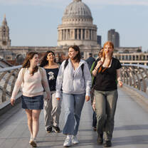 Students walking over a bridge. 