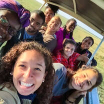 Group photo in safari vehicle.