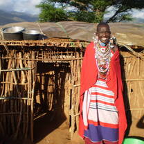 Masai tribe poses in front of home. 