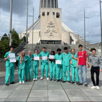 International students in medical scrubs during a clinical skills and healthcare summer programme in Liverpool, UK