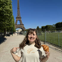 Woman standing beside eiffel tower