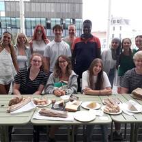 My classmates and I trying authentic French cheese and learning the correct way to cut it during our last language class of the session.