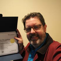 Tom with his new certificate