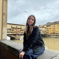 Me sitting near the canal in Florence, Italy