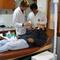 medical volunteers examine a patient