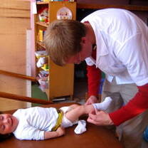 volunteer changing toddler's socks