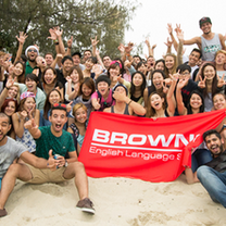 language school students holding up flag 