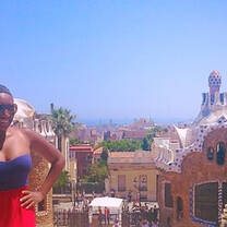 woman smiling on balcony overlooking Barcelona
