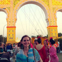 Girl smiling under arch in spain 