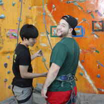 Two teachers preparing to rock climb