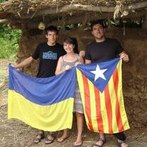 Volunteers hold flags from their home country on a project in Ukraine