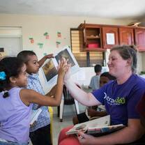 A volunteer and student share a high-five during class!