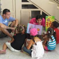 Volunteers and students enjoying the pleasure of reading.