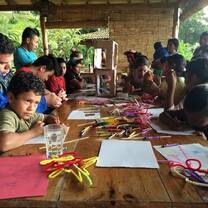 Volunteers conduct an arts and crafts work shop for children in farm communities