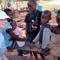 A volunteer works with children in Uganda with Volunteers for Peace