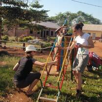 Volunteers paint a slide in Uganda with Volunteers for Peace